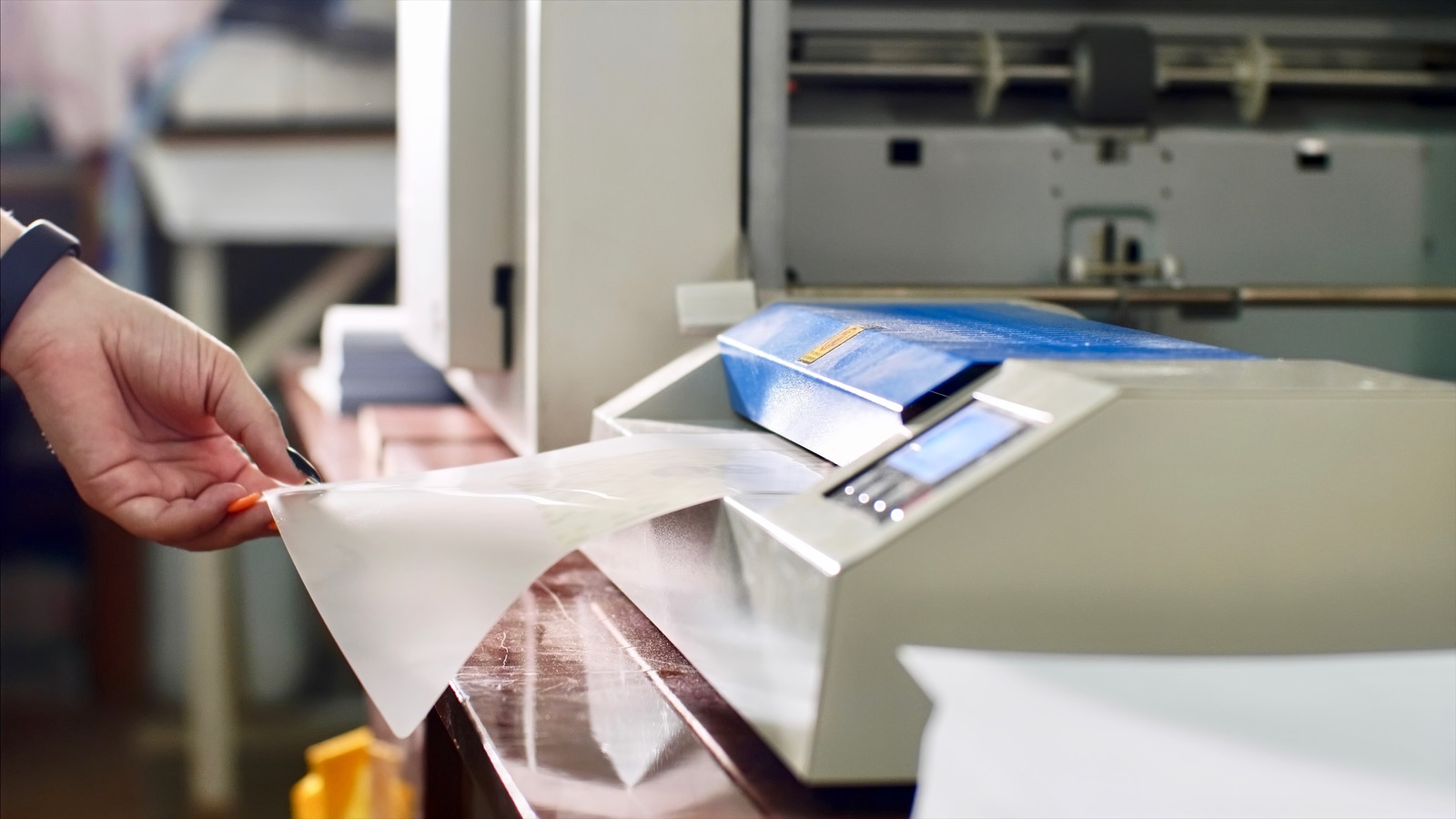 A women doing print lamination in Akron, OH