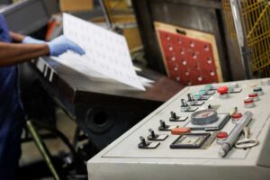 A man doing die cutting as part of print finishing services in Oakwood Village, OH